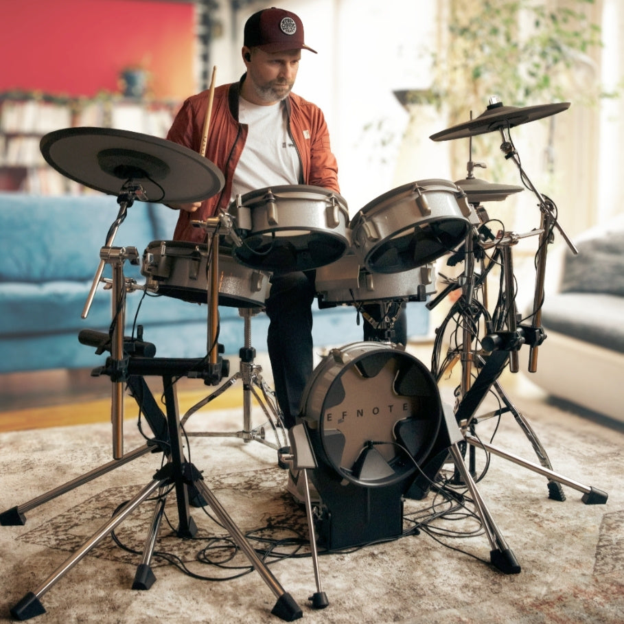 Man playing EFNOTE 3 Style-A — Complete Bundle with Hi-Hat Stand & Kick Pedal electronic drum kit by EFNOTE indoors