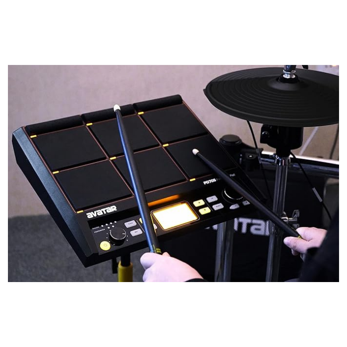 Hands playing the Avatar PD705 Digital Percussion Pad with drumsticks, showing the 9 responsive pads and controls.