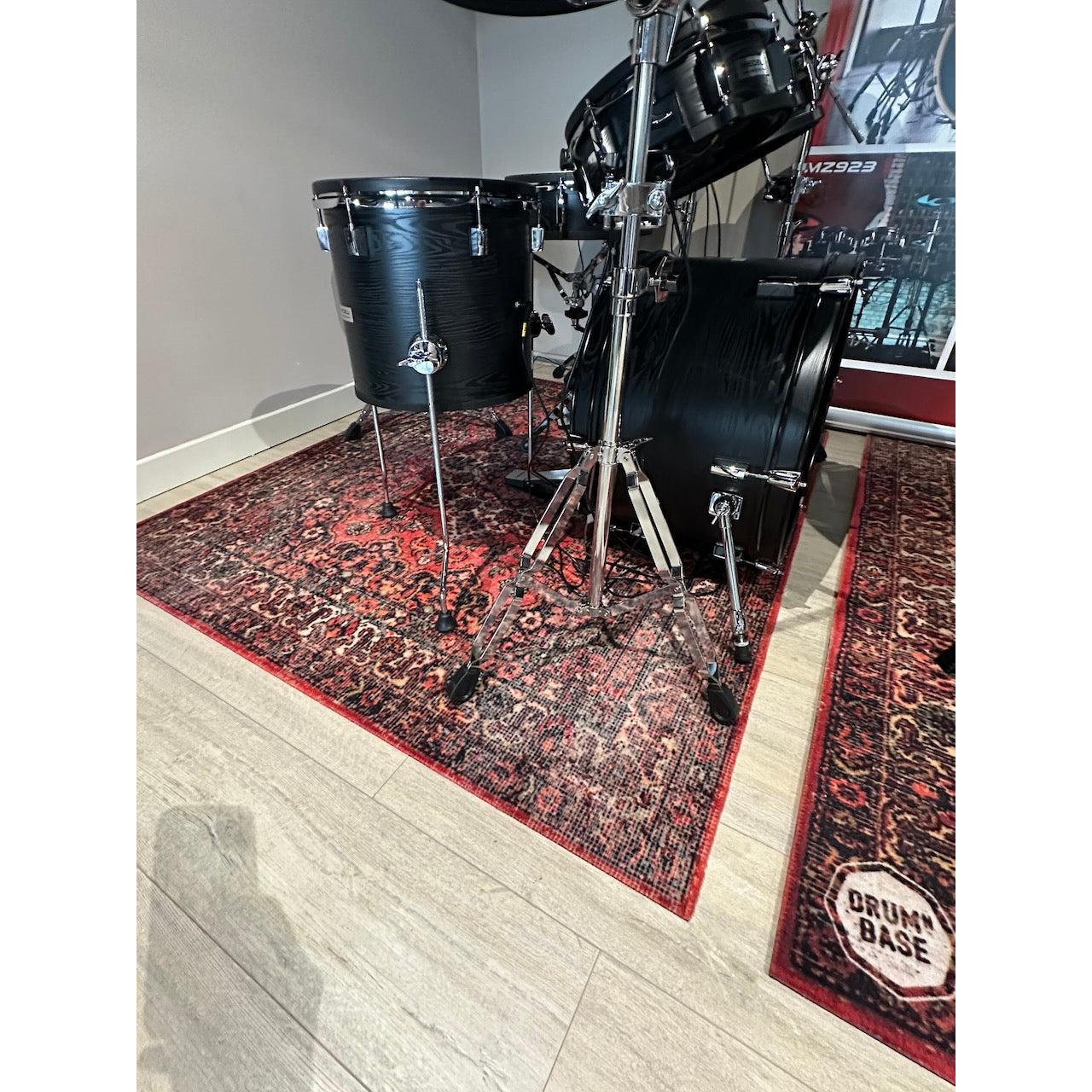 Black drum set on DRUMnBASE Sound STAGE 150×130cm Persian Worn Red Vibration Isolation carpet with intricate pattern