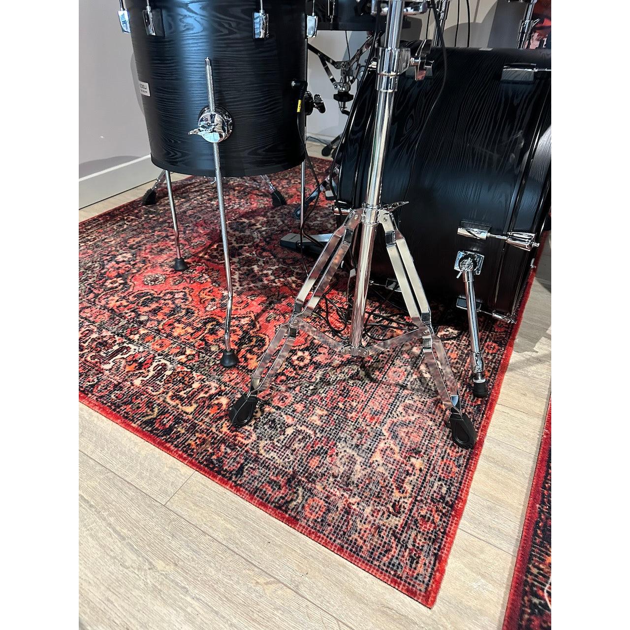 DRUMnBASE Sound STAGE 150×130cm Persian Worn Red Vibration Isolation carpet under black drum kit hardware legs.
