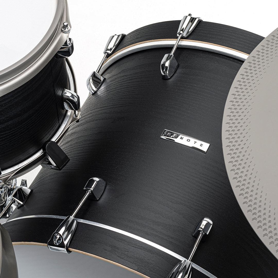 Close-up of black bass drum and hardware on EFNOTE 7X e-drum set showcasing EFNOTE branded badge and cymbal edge.