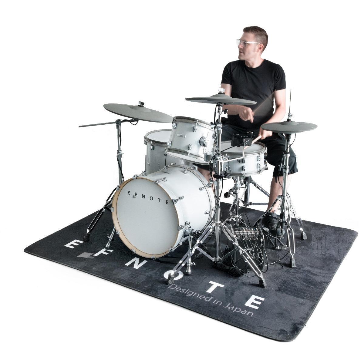 Man playing drum kit on EFNote Drum Rug by EFNOTE, a high quality and stylish drum mat base