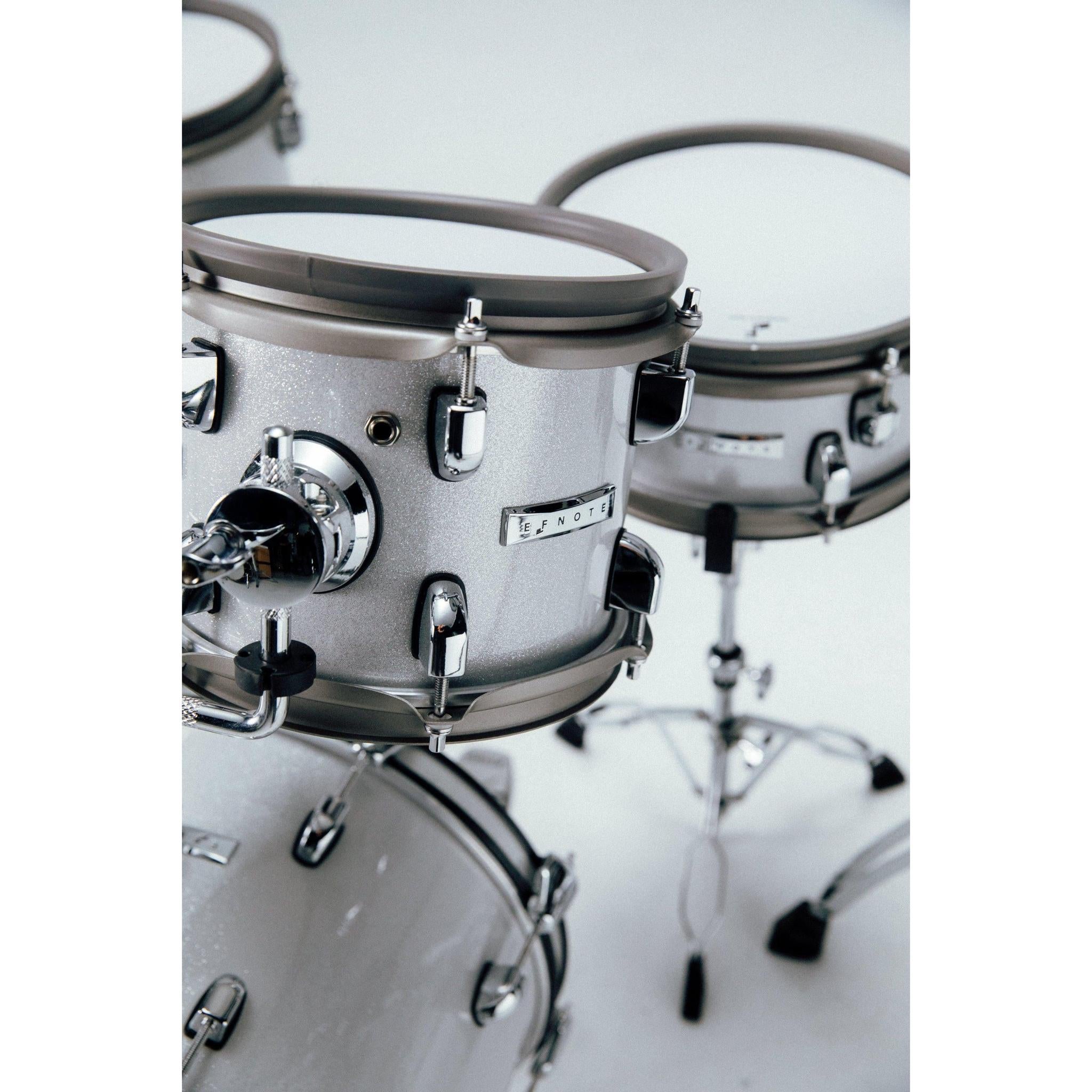 Close-up of silver EFNOTE mini electronic drumset toms with chrome hardware and EFNOTE branding on white background