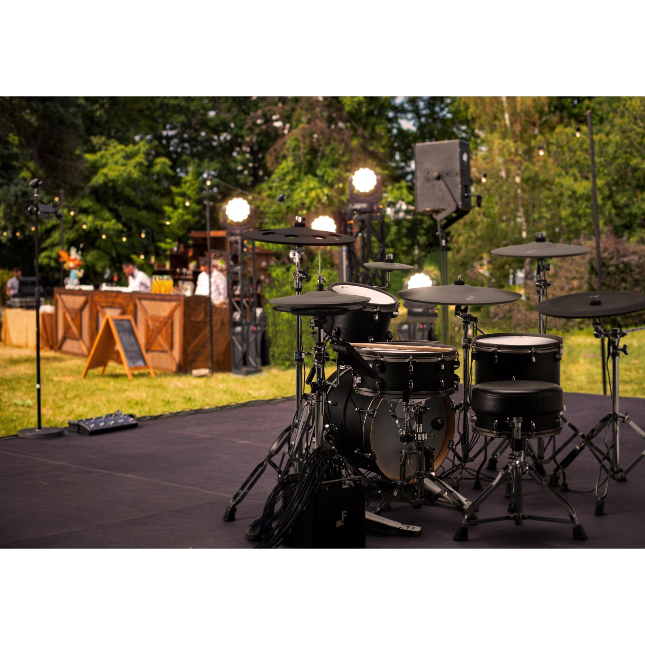 EFNOTE PRO 500X electronic drum kit set up on outdoor stage with professional lighting and sound equipment by EFNOTE