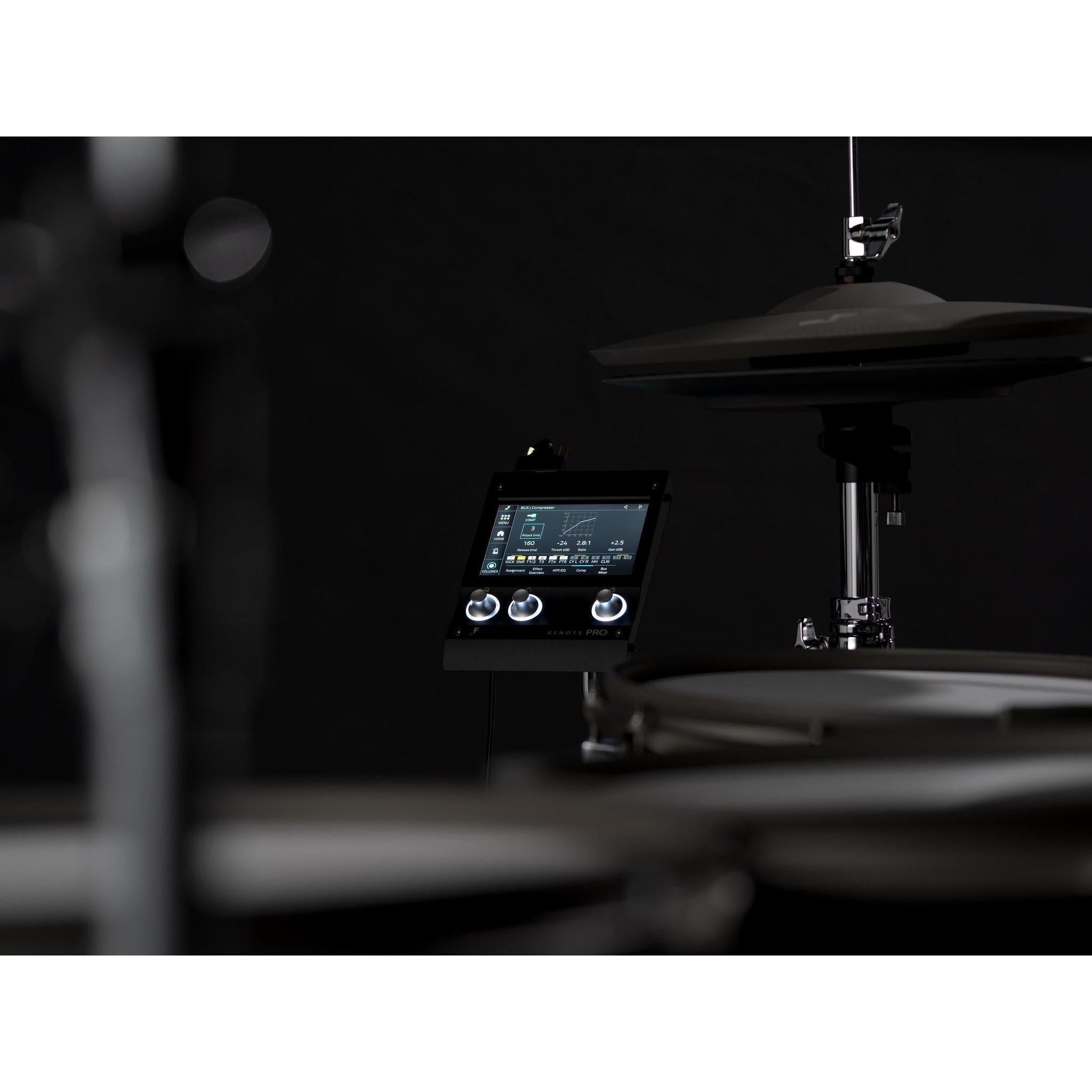 Close-up of EFNOTE PRO 703X electronic drum module featuring a digital display and control knobs on a black background