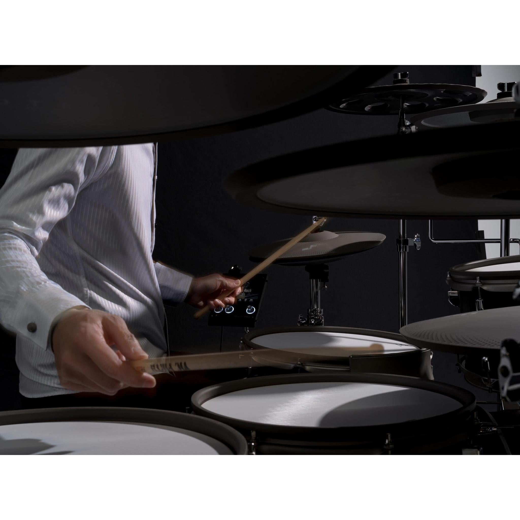 Close-up of a musician playing the EFNOTE PRO 703X electronic drum kit with drumsticks in hand
