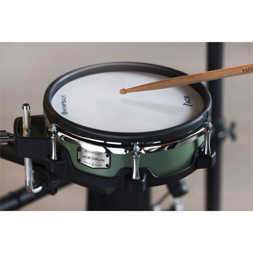 Hampback ACE-530 e-drum set close-up of snare pad with a drumstick striking the drum surface