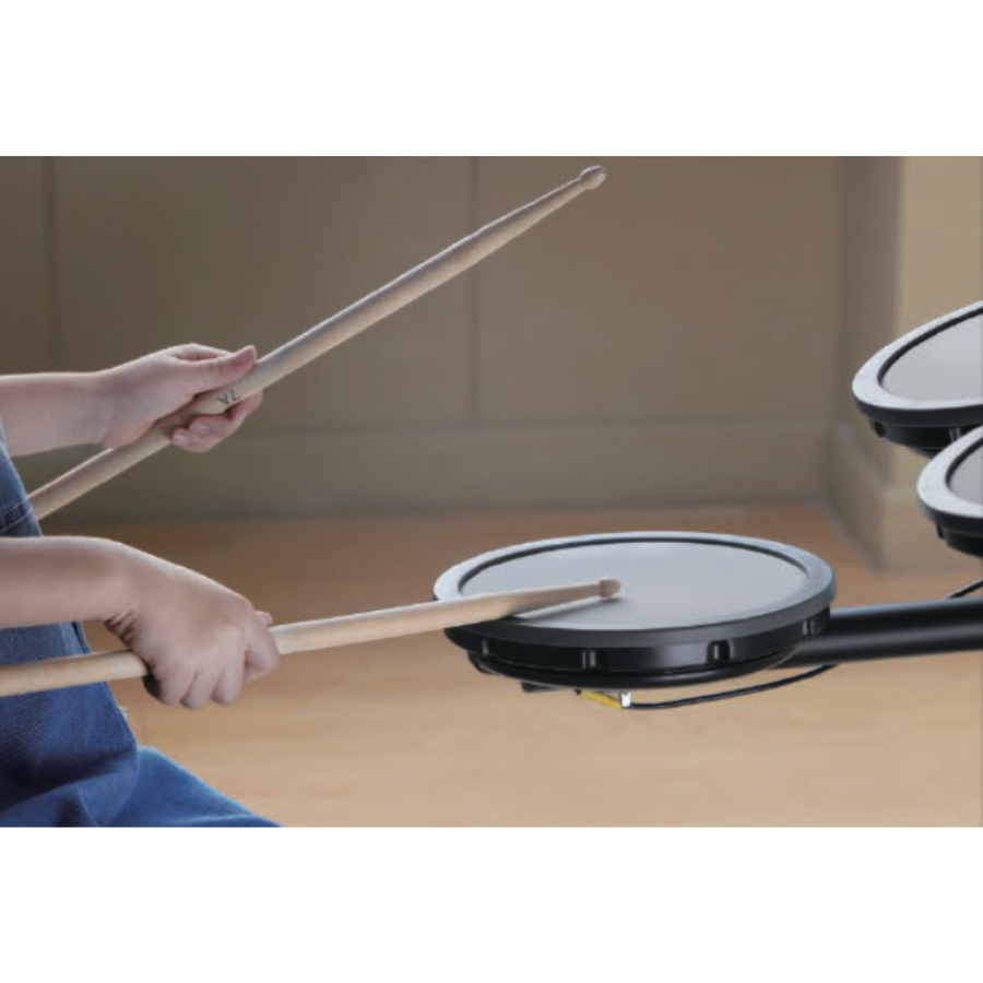 Child playing on Hampback MK-0 electronic drum set for beginners and children with wooden drumsticks in a room