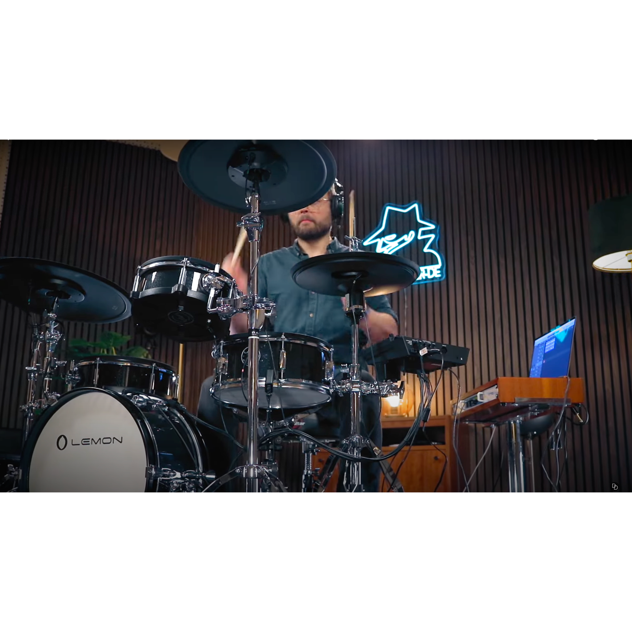 Male drummer playing the black sparkling Jack Lemon drum kit with SpareDrum hardware in a music studio setting