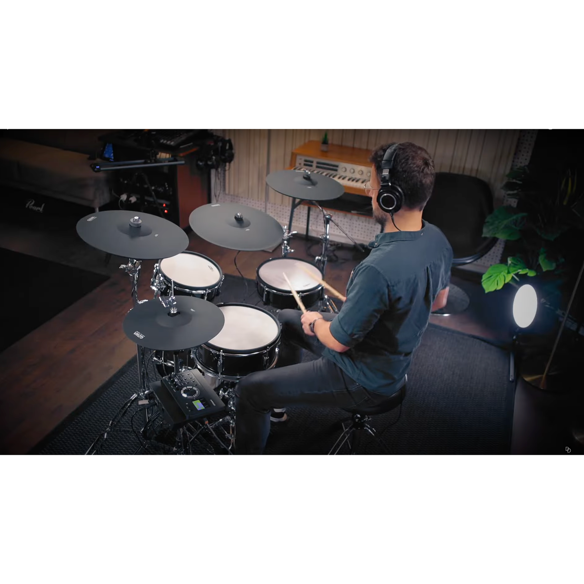 Man playing Jack Lemon drum kit with black sparkling shells and SpareDrum hardware in a home studio setting