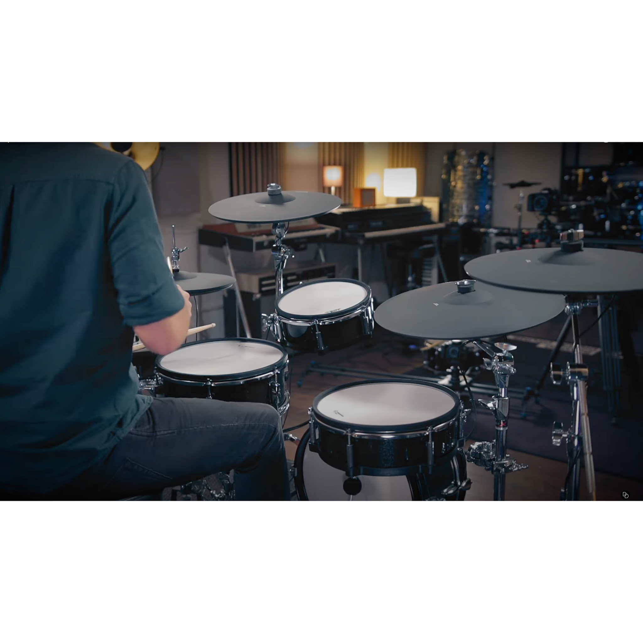 Drummer playing Jack Lemon drum kit with black sparkling shells and SpareDrum hardware in a studio setting