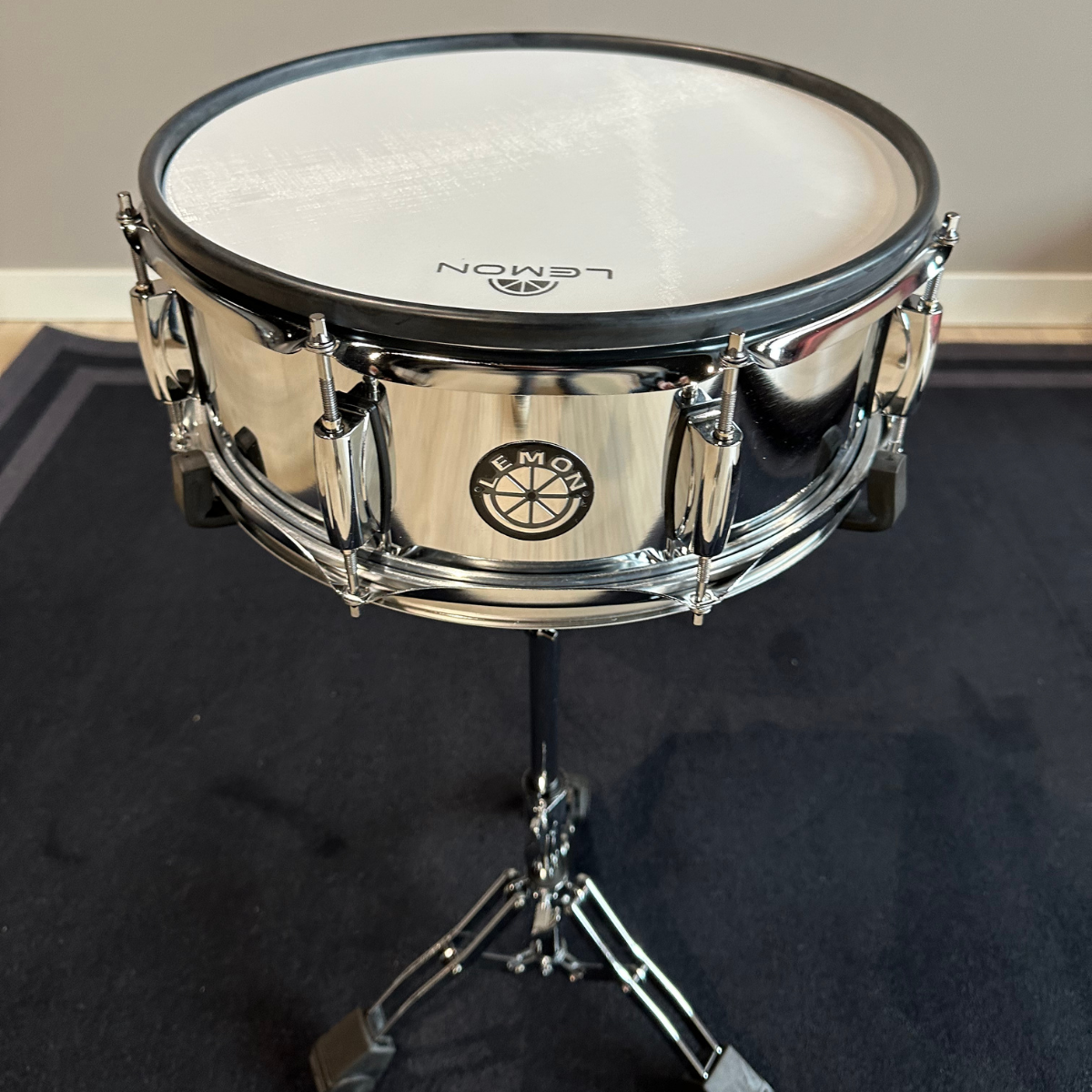 Lemon 14 inch silver metal multi-trigger mesh head snare - LIMITED EDITION on stand with Lemon logo visible