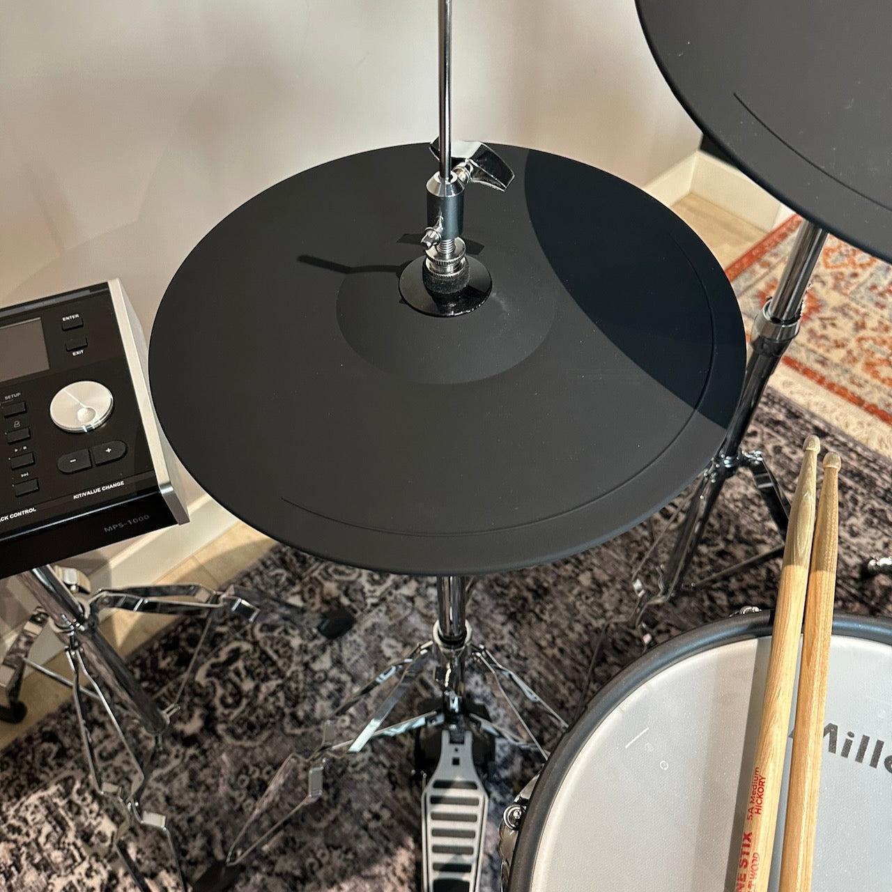 Millenium MPS-1000 E-Drum set (Pre-Owned) featuring black electronic cymbals and drum pads with wooden shells.