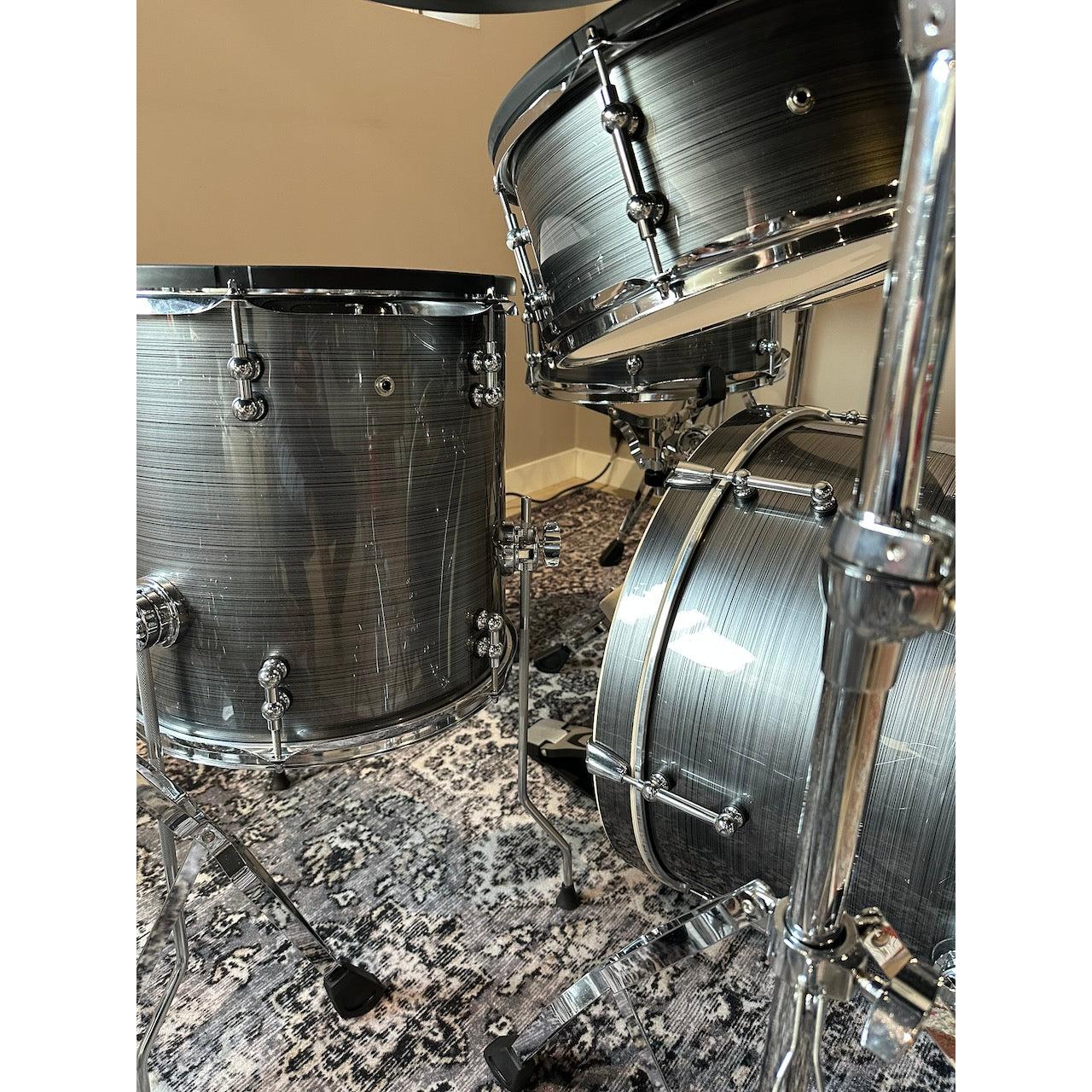 Millenium MPS-1000 E-Drum set (Pre-Owned) showing real wooden shells with chrome hardware on patterned rug.