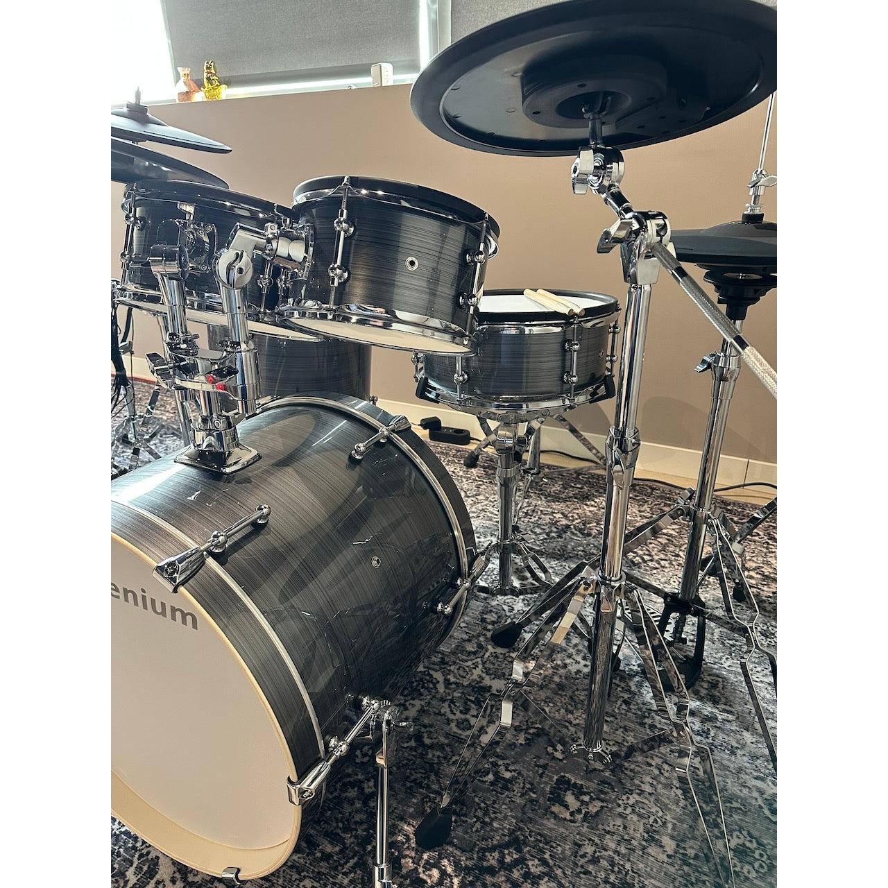 Millenium MPS-1000 E-Drum set (Pre-Owned) with real wooden shells and chrome hardware on patterned rug indoors.