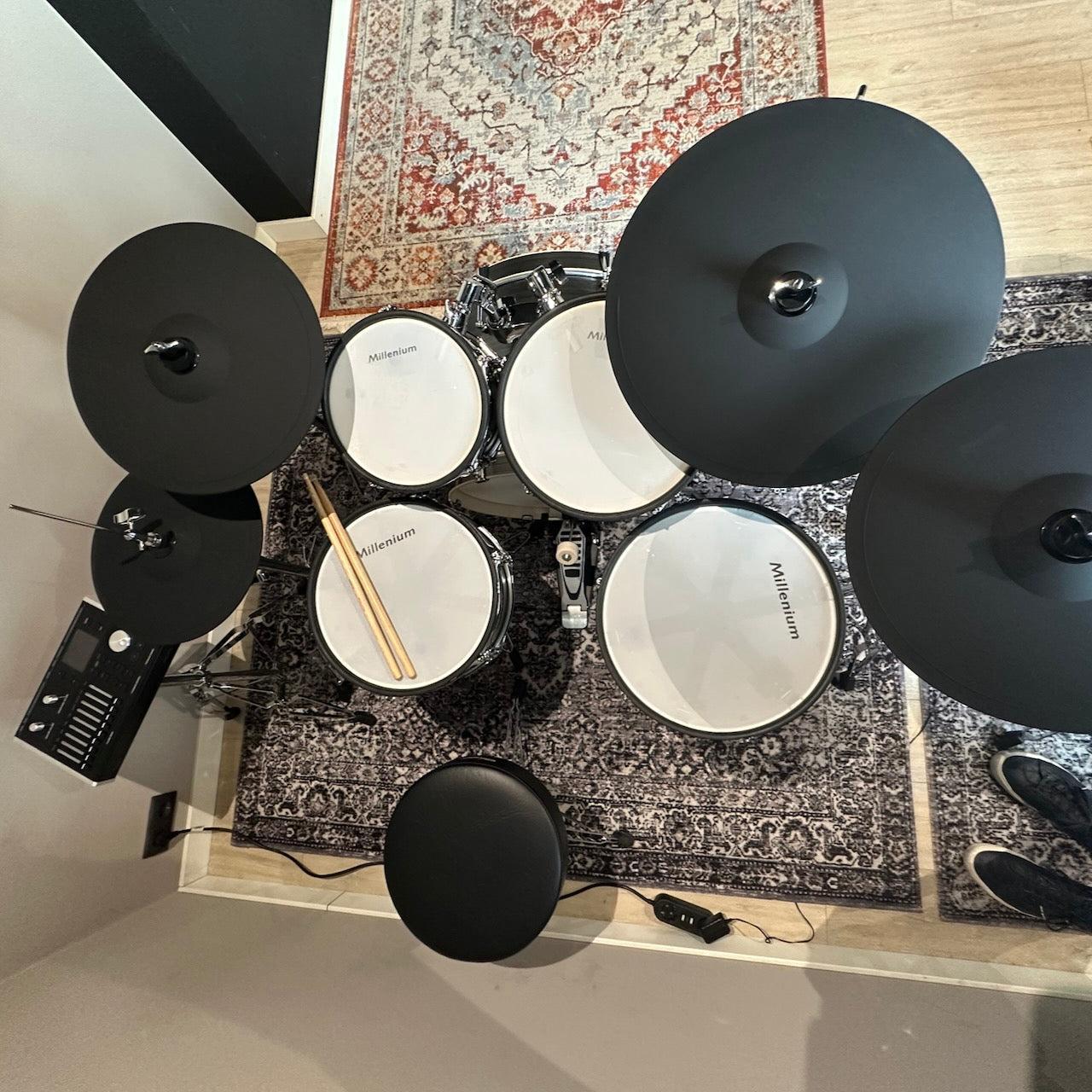 Top view of Millenium MPS-1000 E-Drum set (Pre-Owned) with wooden shells and electronic cymbals on patterned rugs