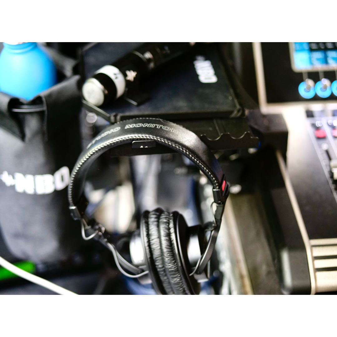 NBO Magnet Pack for Oneboard holding headphones on a black stand with equipment and cables nearby in a studio setting