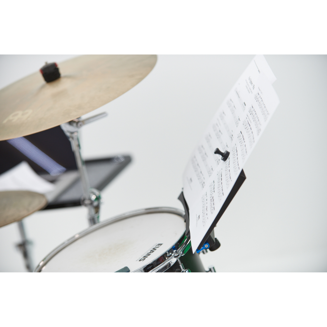 NBO Magnet Pack for Oneboard securing sheet music to a music stand near a drum set and cymbal.