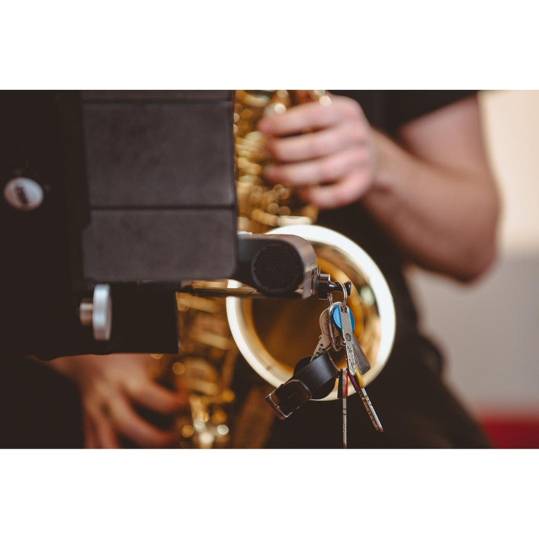 NBO Magnet Pack for Oneboard holding keys attached to a black magnet on a saxophone stand.