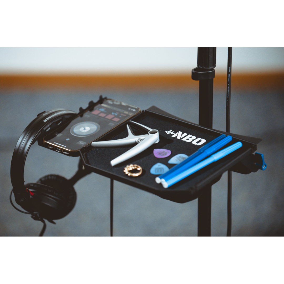 NBO Standard Extension for Oneboard holding headphones, a phone, picks, capo, and drumsticks for organized practice sessions