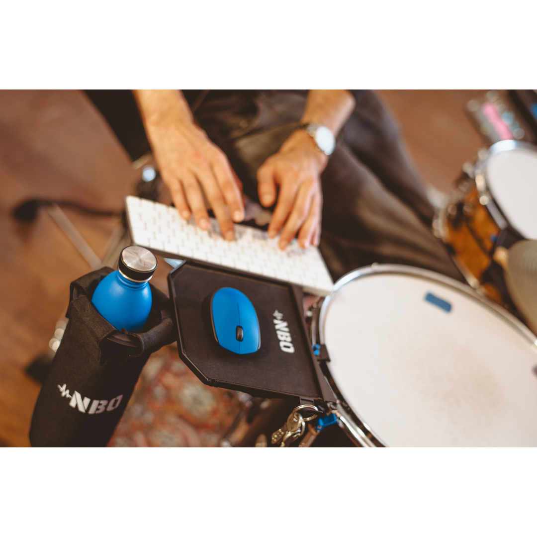 NBO Oneboard - Performance Pack mounted on drum hoop holding water bottle and blue mouse within reach