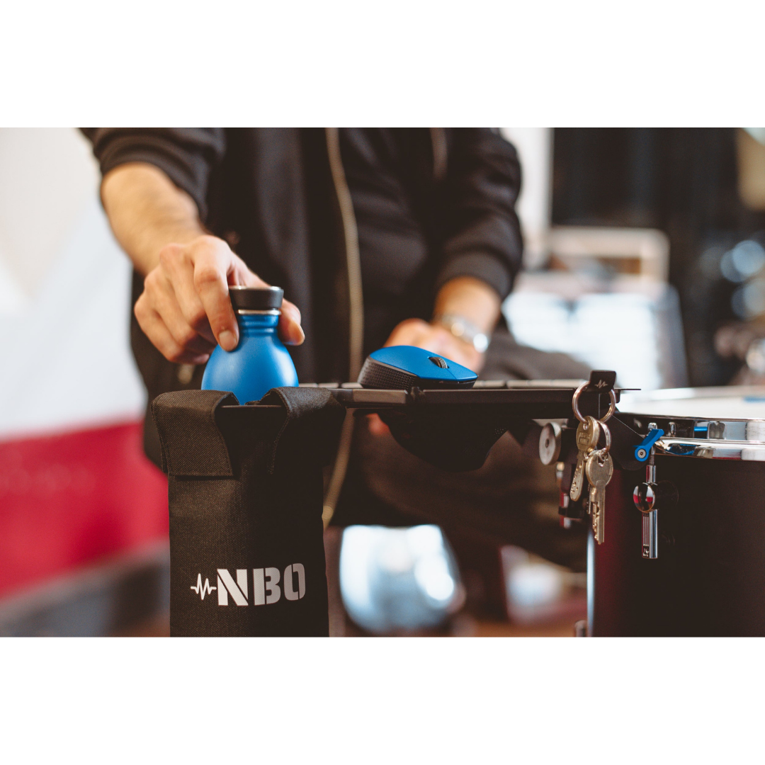 NBO Stick / Drink Holder for Oneboard attached to drum, holding water bottle, mouse, and keys for quick access.