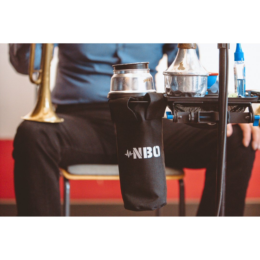 NBO Stick / Drink Holder for Oneboard holding a metal drink container attached to a musical setup with a trumpet nearby