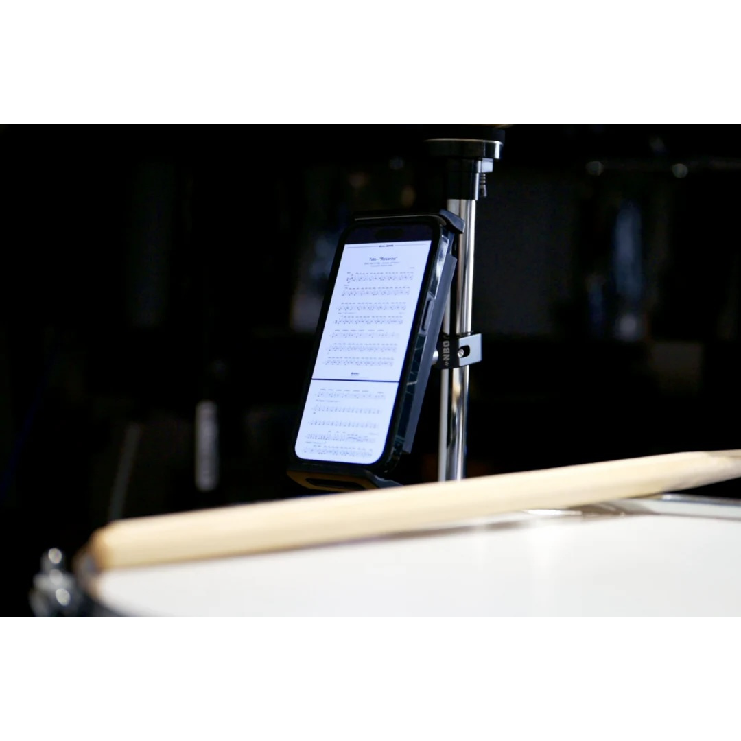 NBO Universal Tablet/Phone Holder mounted on a stand holding a phone displaying sheet music in a music setup