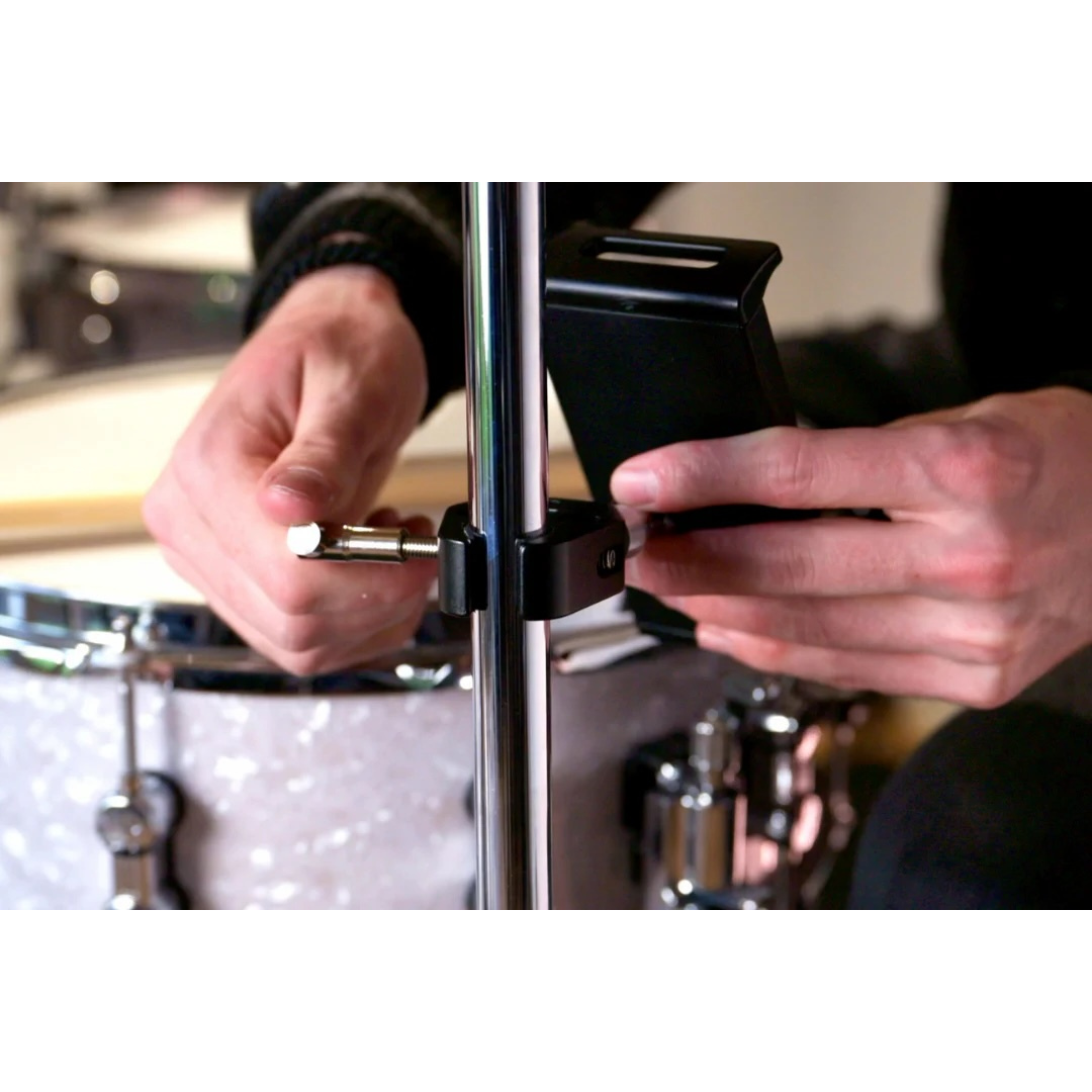 NBO Universal Tablet/Phone Holder being attached to a mic stand near a drum kit for versatile device mounting by NBO