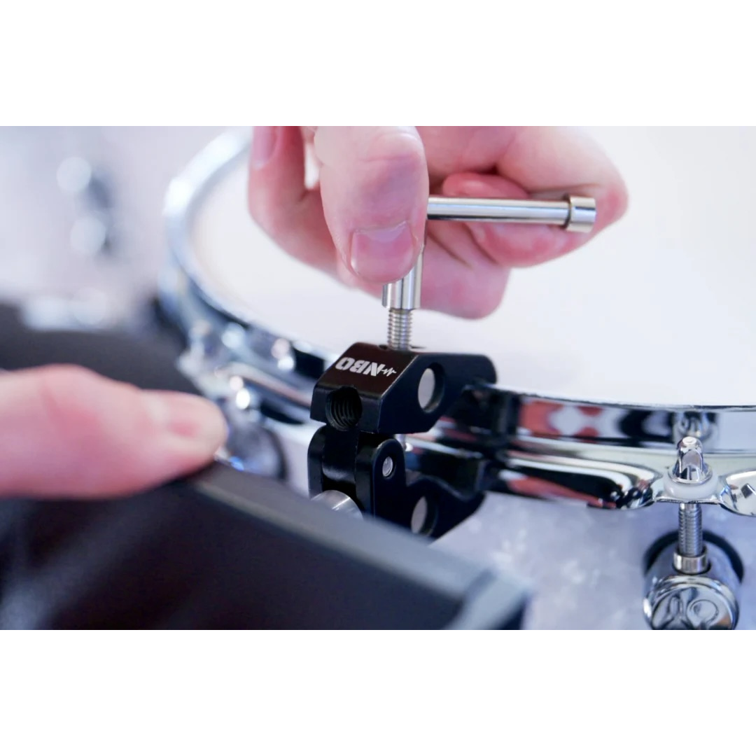 NBO Universal Tablet/Phone Holder mounted on drum rim with hand tightening the clamp for secure attachment.
