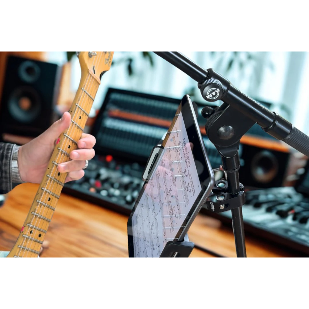 NBO Universal Tablet/Phone Holder mounted on mic stand holding a tablet displaying sheet music near guitar player in studio