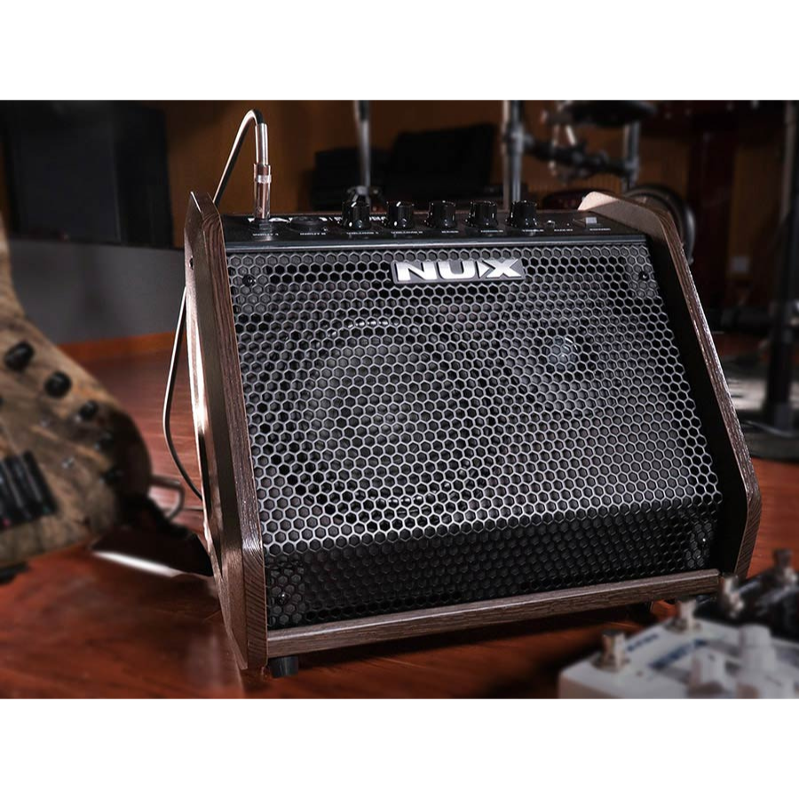 NUX PA-50 Personal Monitor System by NUX front view with wood side panels and metal grille in a music studio setting