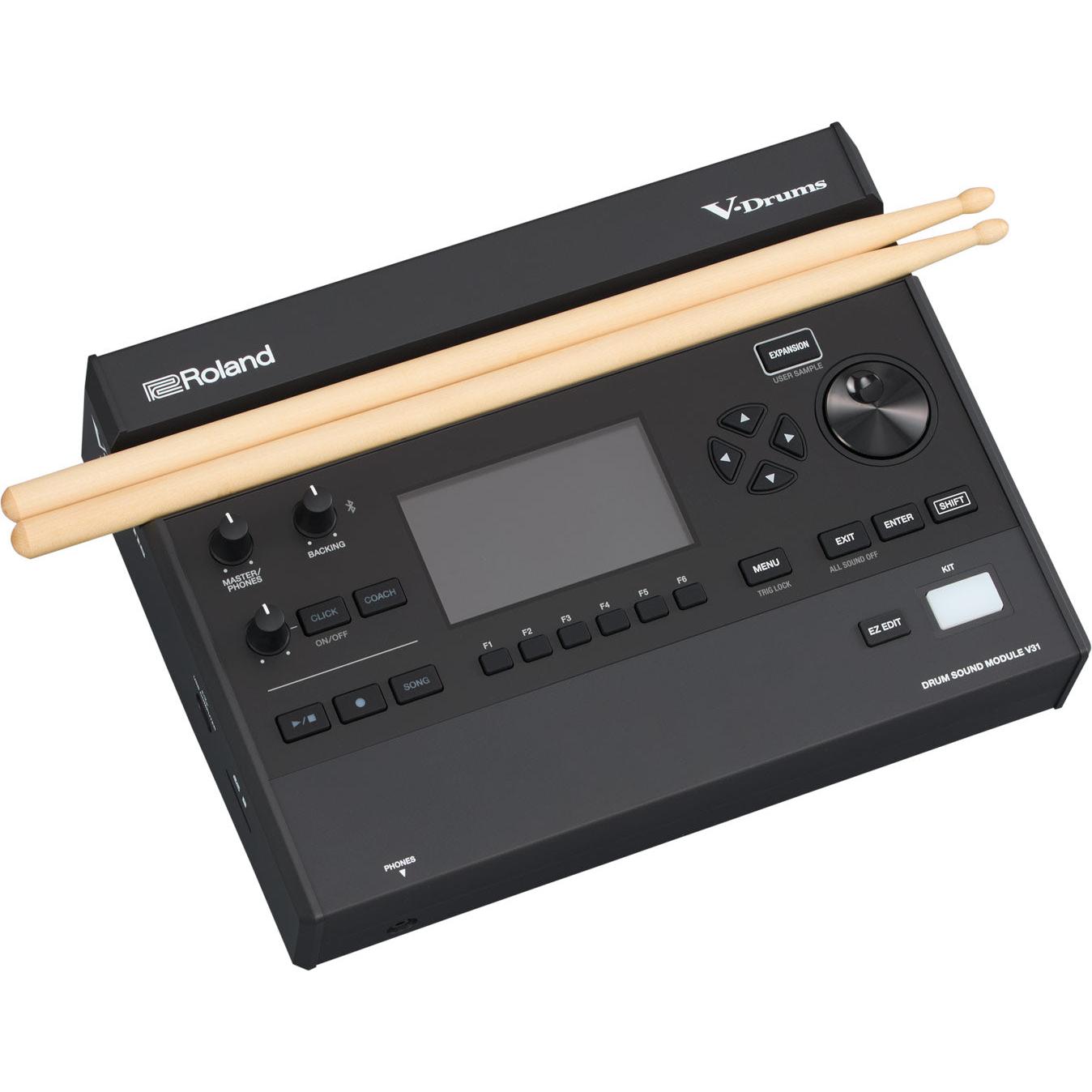 Roland V31 drum sound module, angled view with drumsticks